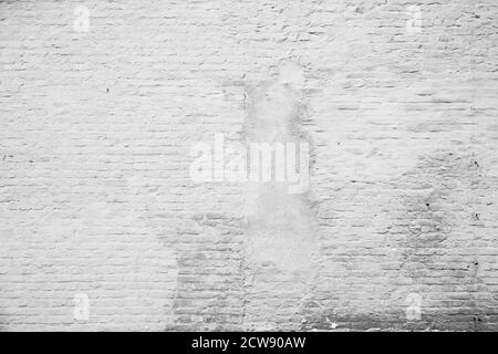 Aged and weathered brick wall, plastered and painted in white. Front view. High resolution full frame textured background in black&white. Copy space. Stock Photo