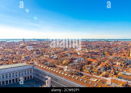 Aerial panoramic view of Venice city old historical centre, buildings with red tiled roofs, Procuratie on Piazza San Marco or St Mark Square, Veneto Region, Northern Italy. Amazing Venice cityscape. Stock Photo