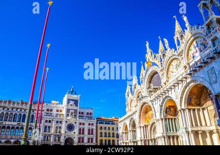 Basilica di San Marco or Cathedral of Saint Mark Roman Catholic church and Torre dell'Orologio clock tower on Piazza San Marco St Mark's Square in Venice historical city centre. Veneto Region, Italy. Stock Photo