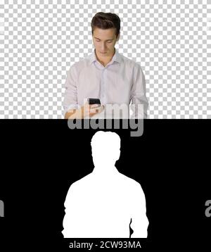 Man in white shirt walking using cell phone, Alpha Channel with Stock Photo
