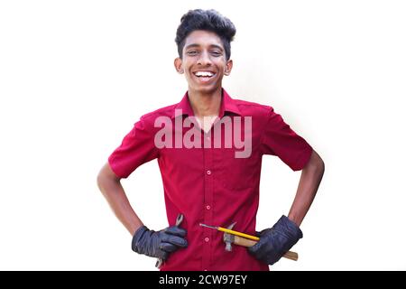 Smiling mechanics working in auto service. hand holding Metalic Wrench, screwdriver with hammer Stock Photo