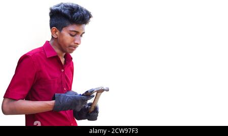 Young mechanics hand holding cutter with hammer, isolated in white backgrounds Stock Photo