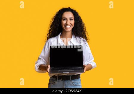 Check This Website. Happy Woman Holding Laptop Computer With Black Blank Screen Stock Photo
