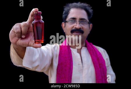Senior man holding something with hand showing at camera Stock Photo