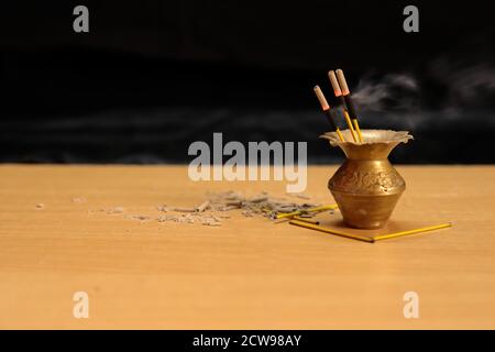 Reed diffuser on wooden table in room on a black wall. Handmade reed freshener Stock Photo
