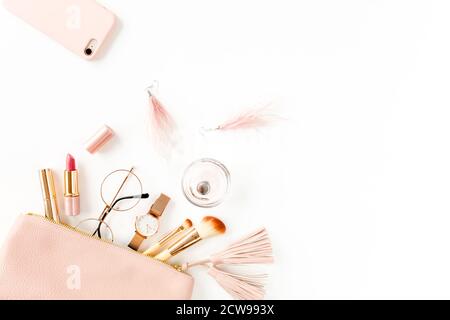 Flat lay composition with pink cosmetic bag with cosmetic makeup products, isolated on white background. Flat lay, top view. Stock Photo