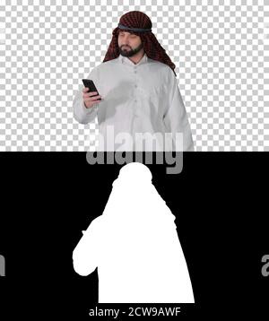 Arab man using his smartphone surfing on the internet or messagi Stock Photo