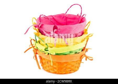 Stack of four colorful empty wicker baskets isolated on white background. Stock Photo