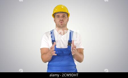 Foreman builder explaining something to camera and talking on gr Stock Photo
