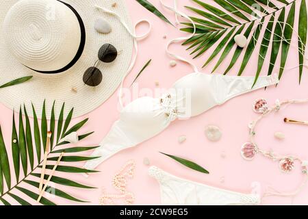 https://l450v.alamy.com/450v/2cw9eg5/traveler-accessories-women-summer-bikini-set-swimsuit-tropical-palm-leaf-branches-on-pink-background-travel-vacation-concept-flat-lay-top-view-2cw9eg5.jpg