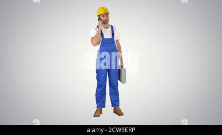 Construction Worker On Telephone on gradient background. Stock Photo