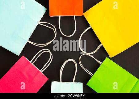Many colorful shopping bags on black background. Stock Photo
