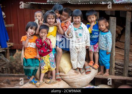 Chiang Mai / Thailand - Jan 16 2016 : Children in the countryside wearing old clothes look poor but in bright colors, stand together for tourists to t Stock Photo