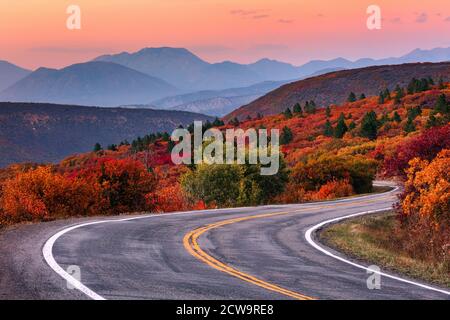 Winding mountain road through a scenic autumn landscape along the West Elk Loop near Gunnison, Colorado. Stock Photo