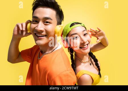 Wearing headphones to listen to music of young couples Stock Photo