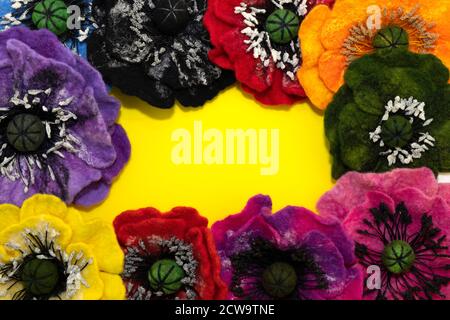 handmade felt, flowers, frame made of felt color with a yellow background inside for an inscription Stock Photo