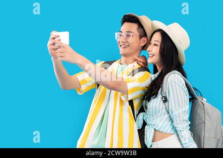 Happy journey young couples with mobile phones Stock Photo