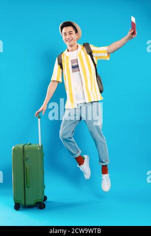 Hold the suitcase bouncing young man Stock Photo