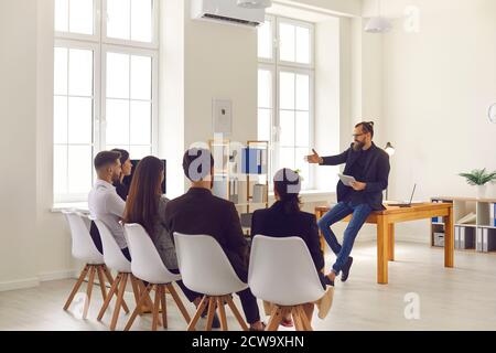 Businessman or executive manager making presentation or training for sitting company workers Stock Photo