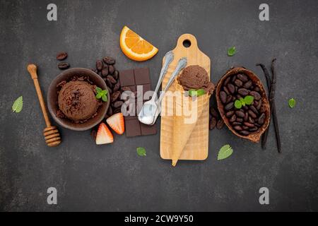 Chocolate ice cream flavours in bowl with dark chocolate and cacao nibs setup on dark stone background . Stock Photo