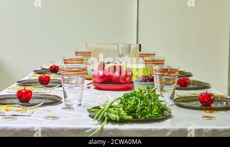 Festively decorated table for Rosh Hashanah with pomegranates and apples. Stock Photo