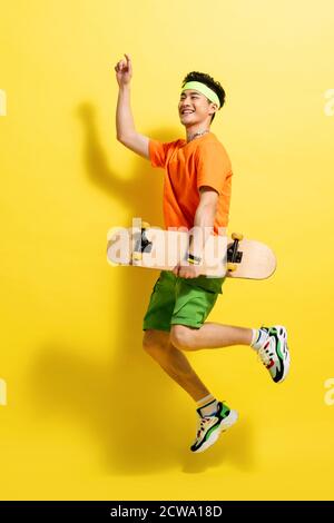 With a skateboard bouncing dynamic young man Stock Photo