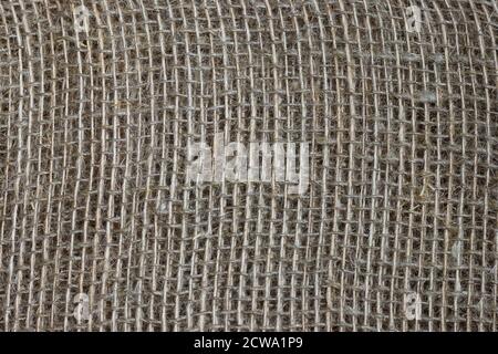 The structure of the threads of a natural burlap fabric close up. Stock Photo