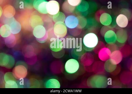 Festive colorful bokeh background with psychedelic colorful sparkles and colorful dots as perfect background for silvester, celebration happy new year