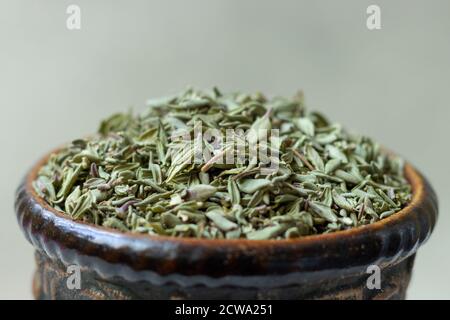 Dried thyme (Thymus) in a earthenware bowl. Stock Photo