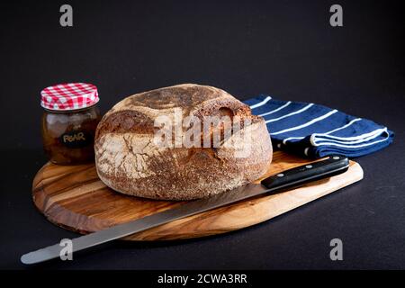 Rye bread on a wooden board with a black background Stock Photo