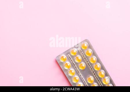 Vitamins pink in the package on a soft pink background. Stock Photo