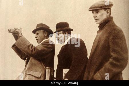 EALING STUDIOS  - BILL BARKER - William George Barker (1868 – b1951) recording the 1908 Grand National Horse Race on an early movie camera. Alongside him are  (l to r) , H H Wrench and F N Cooper. Barker was a British film producer, director, cinematographer, and entrepreneur who began making low budget films  and progressed to  lavishly-produced epics on a quality level with those made by Holywood. Warwick set up the Autoscope Company and later the Barker Motion Photography Limited in 1901 Stock Photo