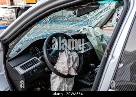 damaged vehicle closeup after a heavy crash, car wreck, exploded airbag, broken windshield Stock Photo