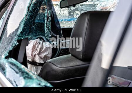 damaged vehicle closeup after a heavy crash, car wreck, exploded airbag, broken windows Stock Photo