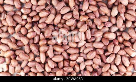 Heap of raw peanuts. Cultivated peanuts, underground or groundnuts. Plant of the legume family. Agricultural crop on an industrial scale. South Americ Stock Photo