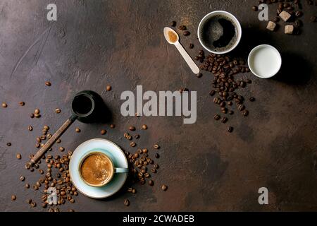 Variety of paper cups of americano coffee and milk versus turkish coffee in ceramic cup and cezve, recycled wooden spoon of cane sugar, coffee beans o Stock Photo