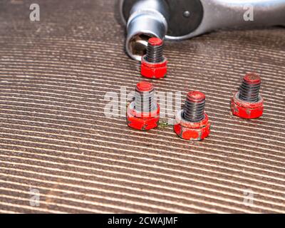 Bolts and nuts loosened with a socket wrench. Stock Photo