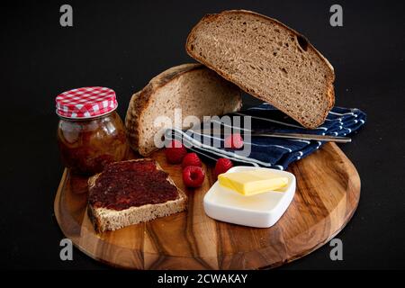Rye bread on a wooden board with a black background Stock Photo