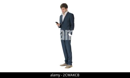 Serious businessman looking at his phone on white background. Stock Photo
