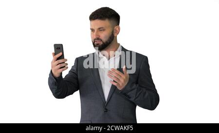 Businessman making a video call with his smartphone on white bac Stock Photo
