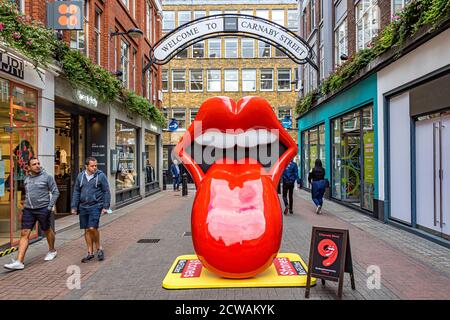 Rolling Stones tongue and lips logo in Carnaby Street, London where the worlds first Rolling Stones retail store, RS No. 9 Carnaby, has opened, London Stock Photo