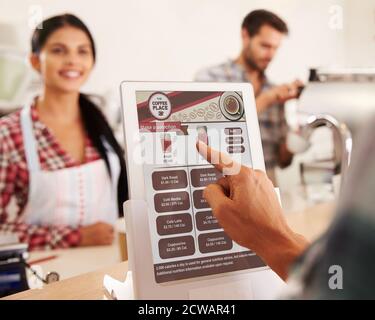 An example of an in-store tablet used by customers to place orders themselves, displaying calorie information for each selection on the digital menu before purchase. This system helps consumers make informed decisions in line with FDA labeling guidelines. Stock Photo