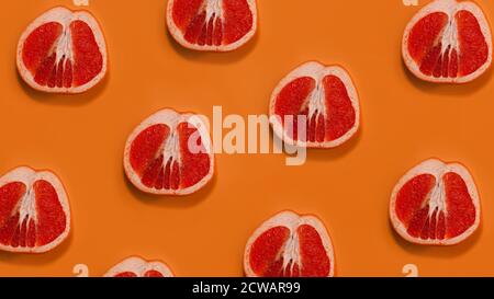 Grapefruit pattern on orange background. Minimal flat lay concept. Stock Photo
