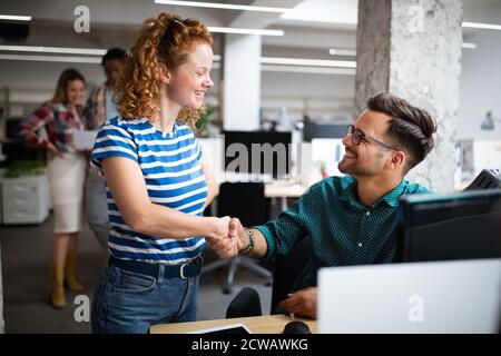 Programmers cooperating at IT company developing apps Stock Photo