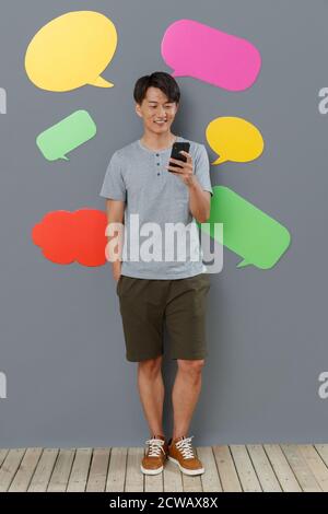 Take the young man mobile phone text messaging Stock Photo