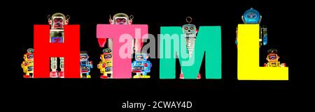 retro tin robot toys hold up the word   HTML isolated on black banner Stock Photo