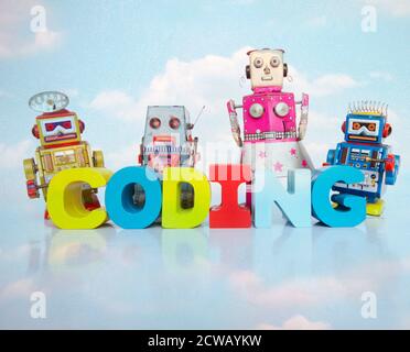 a team of toy robots with the word coding  cloud Stock Photo