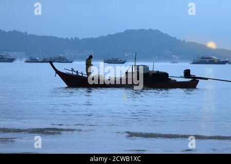 A fishing boat at sunrise in Chalong Bay, Phuket, Thailand Stock Photo