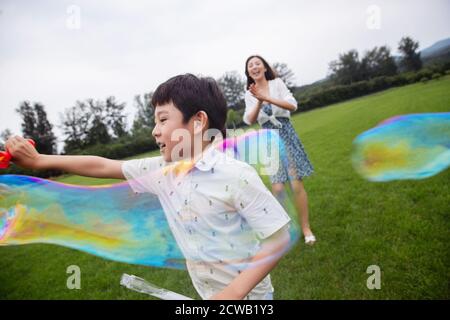 Mother brought the children happy to play on the lawn Stock Photo