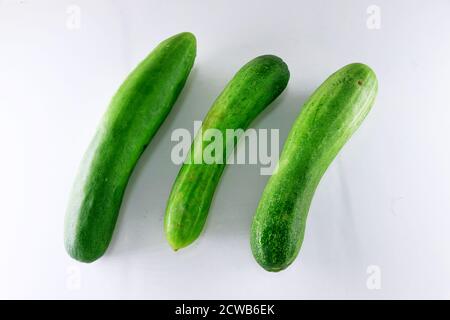 Three fresh cucumbers isolated on white Stock Photo